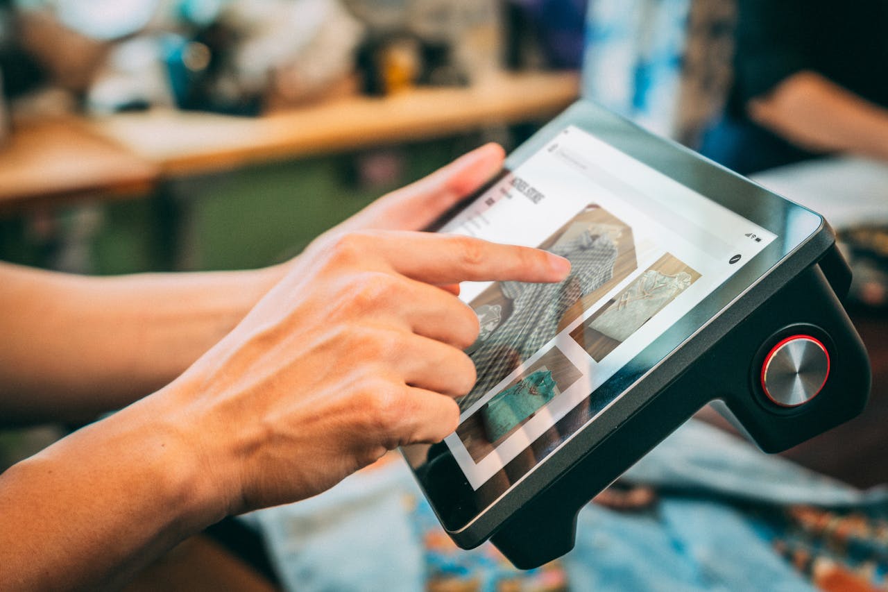 hero-img Close-up of hands interacting with a touchscreen device, showcasing digital content.